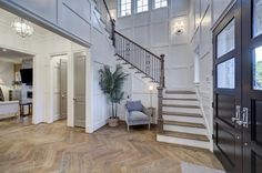 a large foyer with wooden floors and white walls