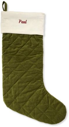 a green christmas stocking with the word paul written in red and white on it