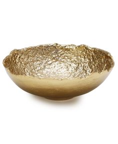 a gold bowl sitting on top of a white table