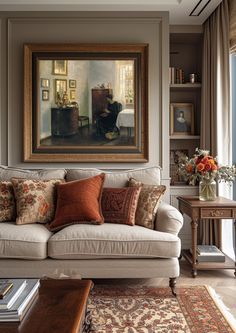 a living room filled with furniture and a painting on the wall