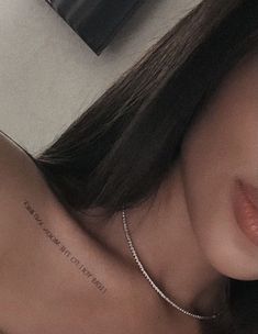 a woman with a tattoo on her chest and the words, don't let it be