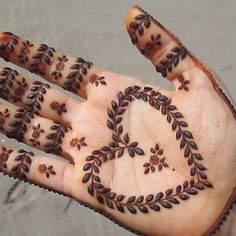 a person's hand with hendi designs on it