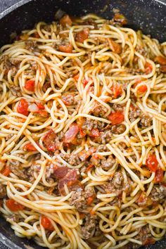 a skillet filled with spaghetti and meat