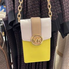 Michael Kors Carmen Small Color-Block Faux Leather Phone Crossbody Bag Sunshn Color: Sunshine Multi / Yellow Crossbody Bag Faux Saffiano Leather 88.92% Coated Canvas/11.08% Polyester Trim: 100% Polyurethane Gold-Tone Hardware 4.25”W X 7”H X 1.25”D Interior Details: 3 Card Slots Lining: 100% Polyester Snap Fastening Imported Yellow Crossbody Phone Bag With Adjustable Strap, Yellow Travel Crossbody Phone Bag, Yellow Crossbody Phone Bag For Travel, Michael Kors Yellow Travel Shoulder Bag, Michael Kors Yellow Shoulder Bag For Travel, Yellow Crossbody Phone Bag With Cell Phone Pocket, Michael Kors Yellow Shopping Bag, Michael Kors Yellow Rectangular Shoulder Bag, Yellow Michael Kors Leather Shoulder Bag