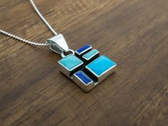 We love all the colors our artists put in our Mosaic Collection. Delivered on an 18" sterling silver faceted bolitas chain (pictured). Weight: 8.5 grams Unique Blue Necklace With Polished Finish, Modern Blue Pendant Jewelry, Artisan Sterling Silver Rectangular Necklace, Rectangular Sterling Silver Jewelry With Inlay, Unique Blue Rectangular Pendant Jewelry, Unique Blue Necklace With Inlay, Unique Blue Rectangular Pendant Necklace, Modern Blue Necklace With Polished Finish, Blue Rectangular Pendant Necklace