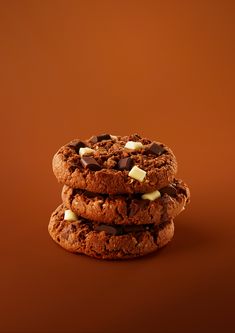 three cookies stacked on top of each other with chocolate chips and marshmallows