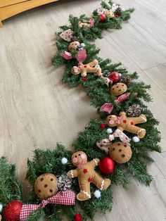 a christmas wreath with teddy bears and other decorations