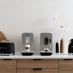 three different types of coffee machines sitting on top of a white counter next to each other