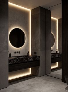 a bathroom with two sinks, mirrors and lights on the wall above them is lit up by recessed lighting