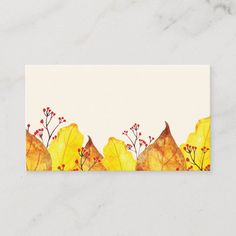 a business card with watercolor leaves and berries on the front, in yellow and red