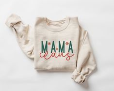 Mama Claus Sweatshirt, Mom Christmas Sweatshirt, Mama Claus Shirt, Mama Christmas Shirt, Mom Christmas Gift, Mama Sweater, Xmas Crewneck  This crewneck sweatshirt is pure comfort. Made from a soft cotton/poly blend with no itchy side seams, this is sure to become a staple. SIZE AND FIT: Your sweatshirt design will be printed on a high-quality, soft and comfortable unisex sweatshirt. Sizes run true to size, which takes the guesswork out of ordering; if you like your sweatshirts loose or oversized, you might want to order a size up and if you'd like a more fitted women's style then order a size down. Sizes range from S - 3X. Please refer to our size chart in the photos for exact dimensions. DETAILS AND FABRIC: * 50% Cotton 50% Polyester * Medium-heavy fabric (8.0 oz/yd² (271.25 g/m * Loose U Christmas Festive Cotton Sweatshirt, Festive Christmas Cotton Sweatshirt, Christmas Gift Cotton Sweater, Holiday Cotton Sweatshirt With Letter Print, Elsa Shirt, Mama Sweater, Nurse Christmas, Christmas Crewneck, Christmas Tops