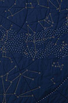 an image of a quilt with stars in the night sky and lines on blue fabric