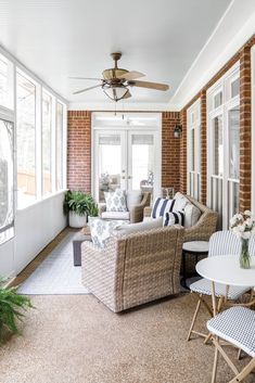 a living room filled with furniture and windows