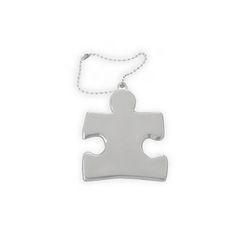 a silver puzzle piece on a white background