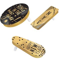 three gold and black skateboards are shown in the shape of an egg with stars on it