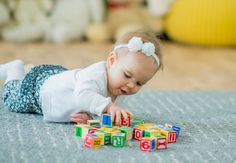 a baby playing with blocks on the floor