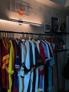 a basketball hoop hangs above a rack of shirts