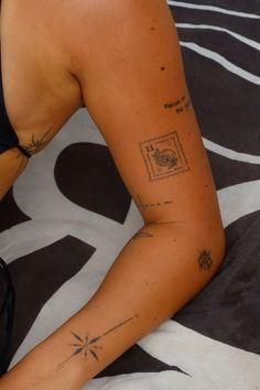 a woman with tattoos on her arm and leg