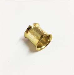 This is a handmade ring made from a bronze sheet then soldered and hammered and finally gold plated 24ct MATERIALS: gold plated bronze DIMENSION:2 cm height(0,8 inch approximately) I can make this ring to your size.You can find your size by looking here:http://www.bluenile.com/pdf/bluenile_ringsizer_copyright2008.pdf Every ring is handmade and unique. You will receive a very similar to the photo but not identical. I will pack your ring in a gift box as in my last photo.See my shop policies here: Artisan Gold Ring With Hammered Detail, Unique Hammered Gold Wide Band Ring, Unique Gold Hammered Wide Band Ring, Artisan Gold Hammered Rings, Artisan Hammered Gold Rings, Hand Forged Gold Wide Band Ring, Hand Forged Gold Wide Band Ring Gift, Architectural Rings, Big Statement Rings