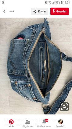 an old jean jacket with zippers is laying on the floor next to a purse