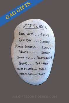 a rock with writing on it and the words weather rock written in black ink, against a gray background