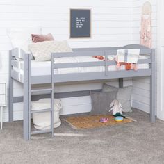 a gray bunk bed sitting next to a white wall