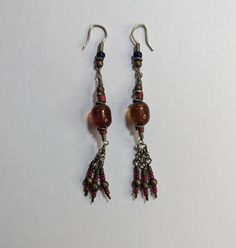 Vintage Handmade Artisan Beaded Earrings Dangle Drop Brown Red Glass Beads Twisted Wire Details 3" Tassel Ends Approximately 3" long Traditional Large Bead Drop Earrings, Traditional Polished Bead Earrings For Gift, Traditional Red Beaded Earrings With Colorful Beads, Artisan Dangle Earrings With Polished Beads, Red Colorful Beads Dangle Earrings, Traditional Large Beaded Drop Earrings, Red Beaded Drop Earrings With Large Beads, Traditional Polished Beaded Earrings For Gifts, Red Beaded Earrings With Large Beads