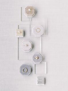 an arrangement of rings and ring boxes arranged on a white surface