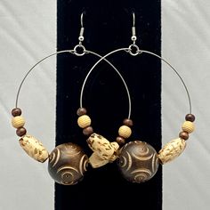 These stainless steel hoop earrings are made with 20mm brown decorative etched wooden beads, tan oval wooden beads and round beads. They are approximately 2 1/4 inch in diameter and 3 1/4 inches long and they have a surgical steel hook. Clear rubber earring backings included. Fredericksburg Va, Ear Rings, Jewelry Earrings Hoops, Wooden Beads, Round Beads, Etching, Etsy Earrings, 4 Inch, Hoop Earrings