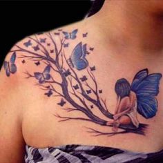 a woman's chest with blue butterflies on it and a tree in the background