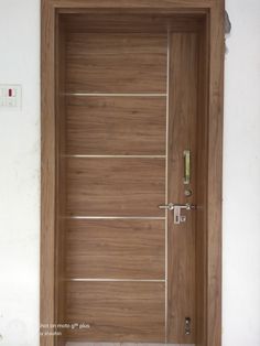 an open wooden door in a white room