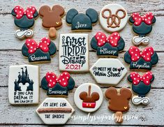 mickey mouse cookies are arranged on a wooden table with the names of each character and their respective characters