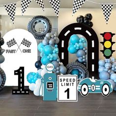 an assortment of balloons and decorations for a race themed birthday party