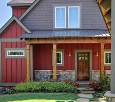 a red house with stone steps leading to the front door