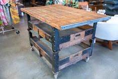 a wooden table sitting inside of a store