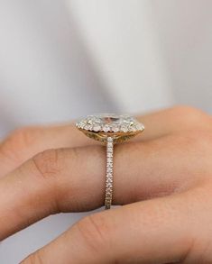 a woman's hand with a diamond ring on it