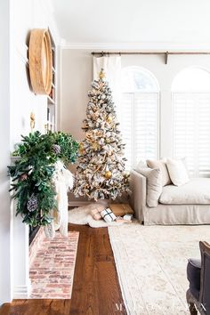 a living room with a christmas tree in the corner