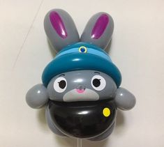 an inflatable balloon shaped like a rabbit with a hat on it's head