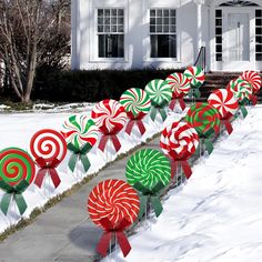 candy canes lined up in front of a white house