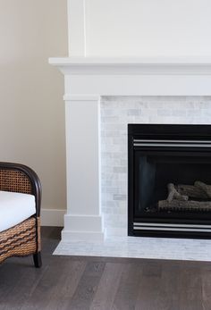 a white fireplace with a black and white sign above it