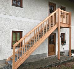 a wooden staircase leading up to a white house