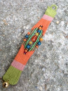 an orange and green bracelet with beads on it