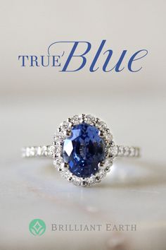 an engagement ring with a blue sapphire in the center and white diamonds around it on top