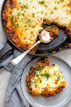 a casserole with meat and cheese is shown on a plate next to a fork