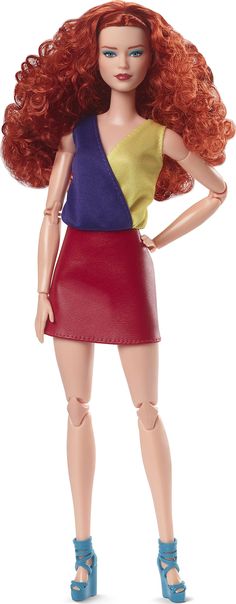 a doll with red hair is wearing a skirt and sandals on her feet, while standing in