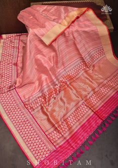 The Banarasi Silk Brocade sarees are a treasured Handloom that portray history and rich craftsmanship! This saree comes in a Peach Pink shade with gold and  Silver blending beautifully in this interweave of silk and zari! The red Kadhiyal  Border with zari makes the saree more charming. SILK MARK CERTIFIED The saree is ready to wear with falls and pico done. Hand knotted tassels add charm.  An unstitched blouse fabric is included. *Note: There may be minor variations in the shade, the texture of Semi-stitched Traditional Wear With Border For Wedding, Eid Paithani Silk Pre-draped Saree With Self Design, Semi-stitched Pre-draped Saree With Zari Weaving For Navratri, Bollywood Style Pre-draped Saree With Border For Eid, Navratri Pre-draped Saree With Border, Festive Banarasi Silk Pre-draped Saree With Self Design, Traditional Festive Pre-draped Saree With Border, Diwali Pre-draped Saree With Zari Weaving, Bollywood Banarasi Silk Pre-draped Saree With Border