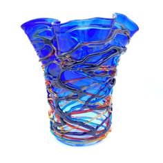 a blue glass vase filled with lots of different colored lines