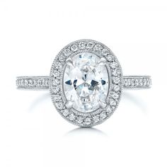 an oval cut diamond ring with pave set shoulders