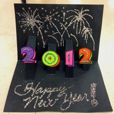 a new year's card with fireworks in the background and 2012 written on it