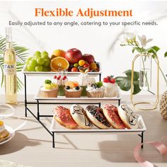 three tiered trays filled with fruit and pastries on top of a table